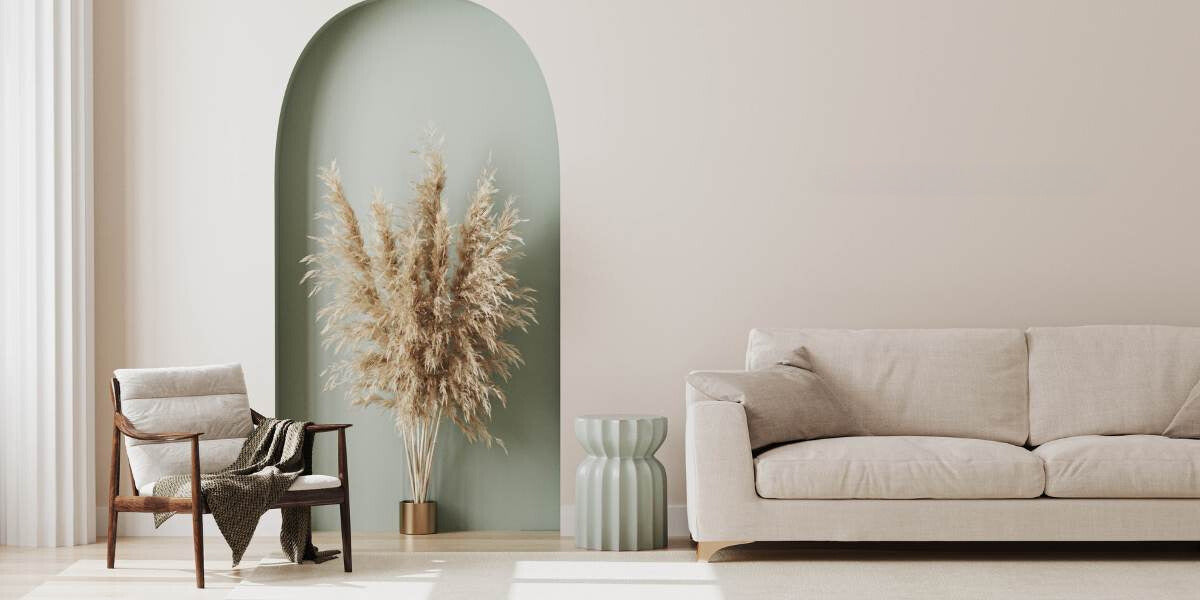 living room scene with chair, sofa, vase and pampas grass