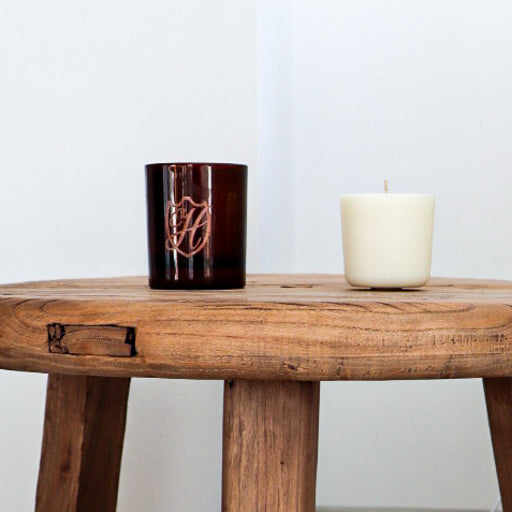 Wax candle refill next to candle holder
