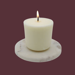 lit fall refill candle on marble slab