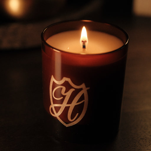 Brown glass jar candle lit flame