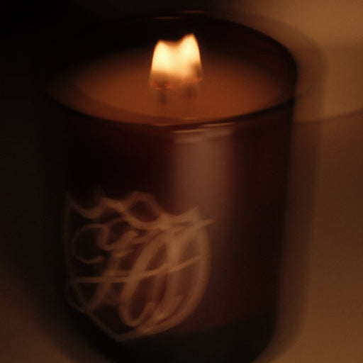 blurred candle with lit flame in a dark room