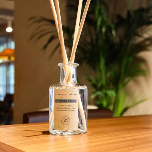 Glass diffuser with wooden reeds on a wooden table