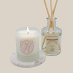 lit spring sakura candle in refill with spring sakura diffuser in bottle with reeds