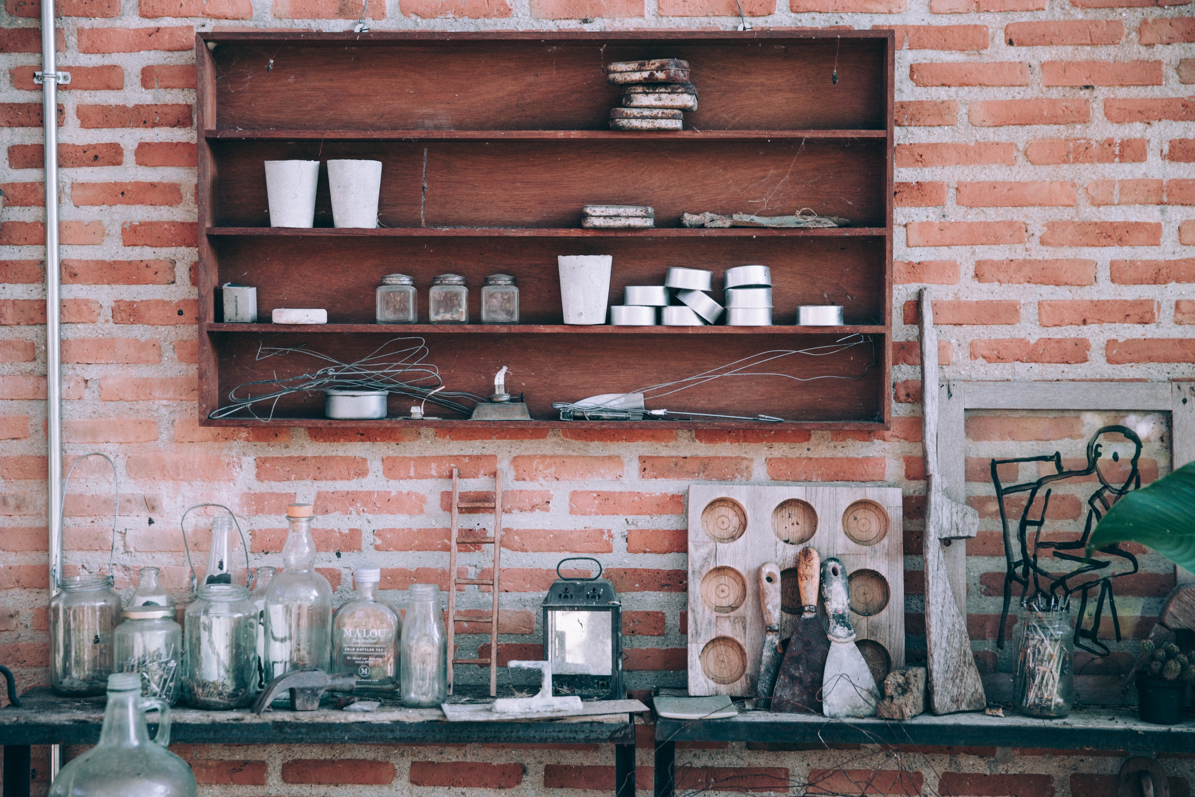 workshop bench with tools and a bricked wall